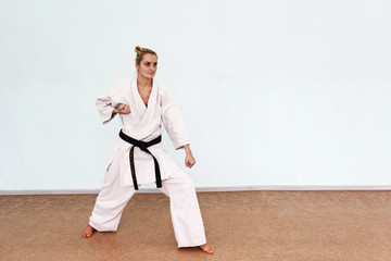 The girl in a white kimono plays sports