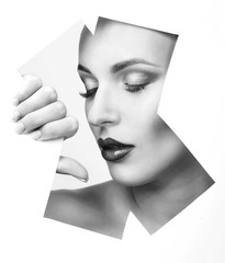 Girl with glamorous makeup looks through the geometric pattern in the paper