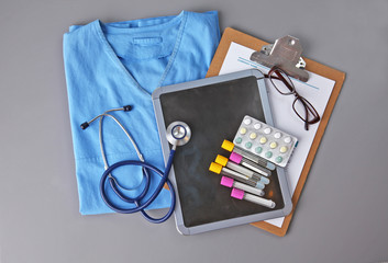 Stethoscope and some pills - isolated on a white background