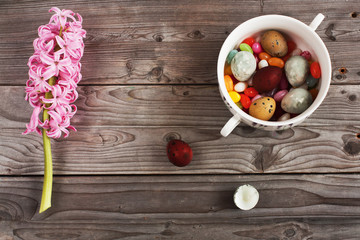 Easter eggs and hyacinth on a wooden beckground.