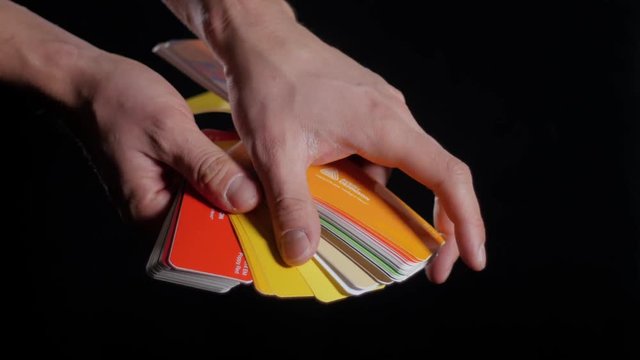 Color sampler for exterior vinyl siding isolated on black, desinger hands