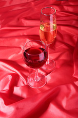 Two Glass of red, white wine on red background