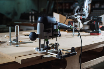 Young man working as carpenter and cutting board