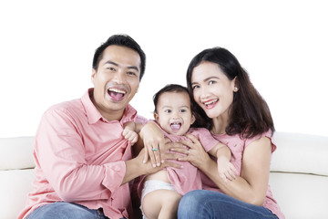 Family sitting on couch laughing together