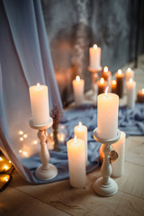 Romantic interior for Valentine's day with candles lights burning in room.