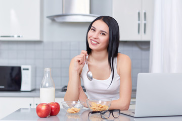 Girl eating oak flakes and milk.