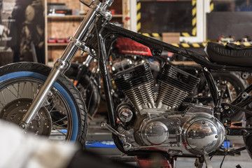 Fototapeta na wymiar Motorcycle with various tools situating in garage
