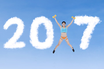 Naklejka premium Fit woman jumping with 2017