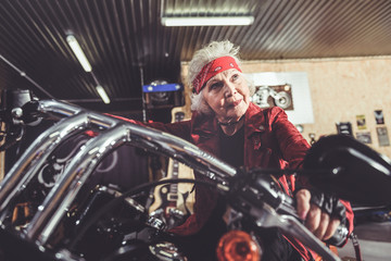Fototapeta na wymiar Cheerful retiree driving out of garage