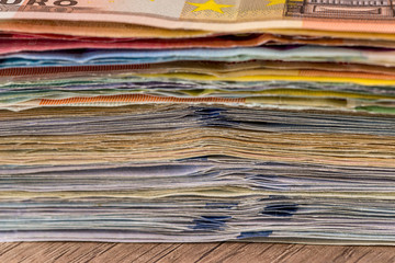 Folded stack of dollar, euro banknotes as background