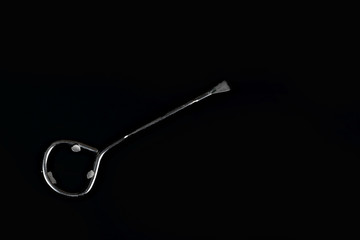  Paint can opener on black background