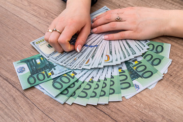 Woman holding 100 euro bills. money concept.