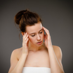 Fototapeta premium Woman massaging pain head 