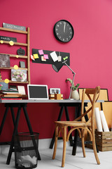 Workplace with laptop on table in modern room