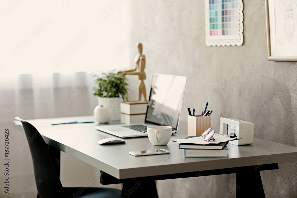 Wall mural workplace with laptop on table in modern room