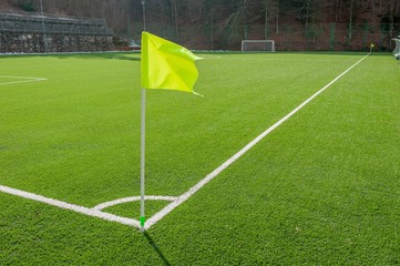 corner in the football field with artificial turf flag