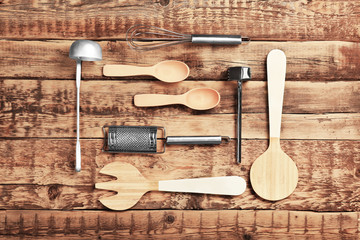 Set of different kitchen tools on wooden table