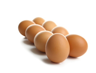 Raw eggs on white background