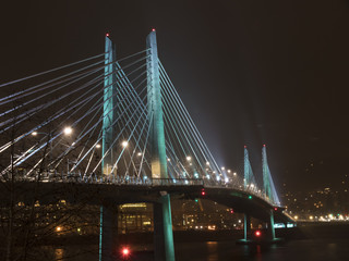 Fototapeta na wymiar Tilikum Bridge on rainy night with lights