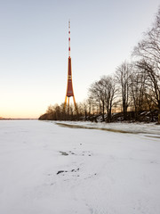frozen beach in cold winters day with TV tower in background