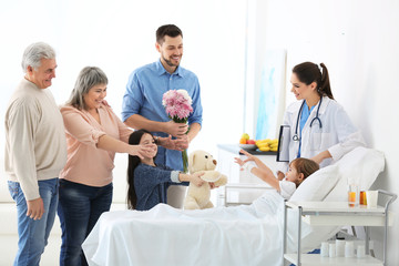 Family visiting little girl in hospital