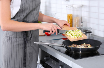 Woman cooking delicious dinner at home