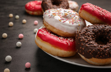 Tasty donuts on plate, closeup