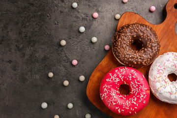 Tasty donuts on cutting board