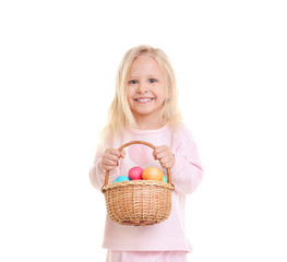 Fototapeta na wymiar Cute funny girl holding wicker basket with Easter eggs on white background