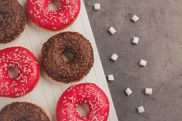 Tasty donuts on cutting board