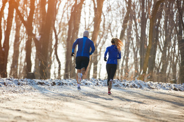 Two persons jogging in nature together