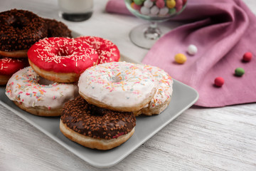 Tasty donuts on table