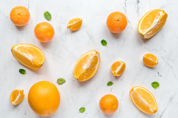 Making orange juice with mint on table background top view pattern
