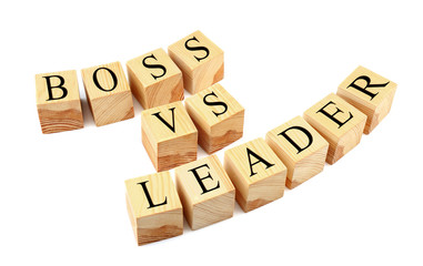 Wooden cubes with text BOSS VS LEADER isolated on white