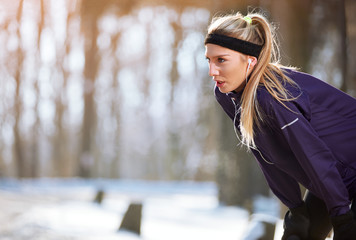 Sportswoman resting from running  .