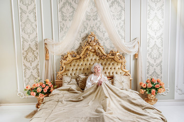 Fototapeta premium Alone senior queen resting in bedroom