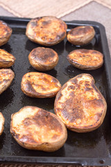 Baked potatoes in the oven on the frying pan