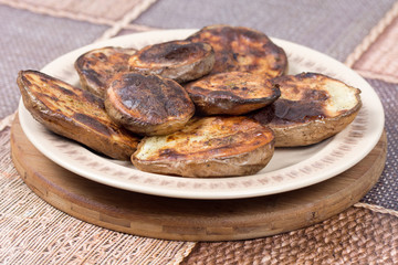 Baked potatoes with shell served on the plate