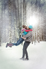 Girl and man play in the snow