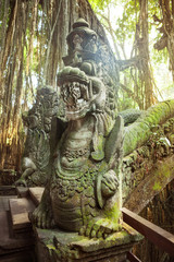 Fototapeta na wymiar Statues and demons, gods and Balinese mythological deities on bridge