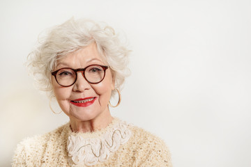 Joyful senior lady in glasses laughing