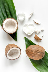 Obraz na płótnie Canvas organic cosmetics with coconut on white background top view