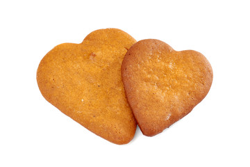 Two heart shaped gingerbread cookies on white