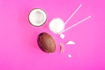 cocktail with coconut on purple background top view