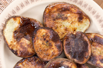 Served baked potatoes with shell on the plate