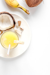 cocktail with coconut on white background top view