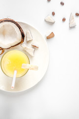 cocktail with coconut on white background top view