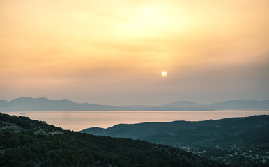 Obraz premium Sunrise view of mountains and sea on Aegina island, Greece.