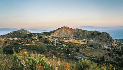 Sunrise view of mountains and sea on Aegina island, Greece.