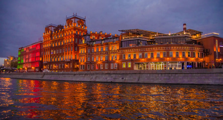 Moscow night landscape with river and red october factory.